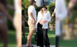 Read more about the article Margot Robbie’s Take On Maternity Fashion Came In A Bump-Baring White Shirt With Black Flared Pants