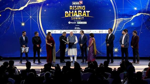 Network18 presents PM Narendra Modi a special edition book at Rising Bharat 2026 – Firstpost